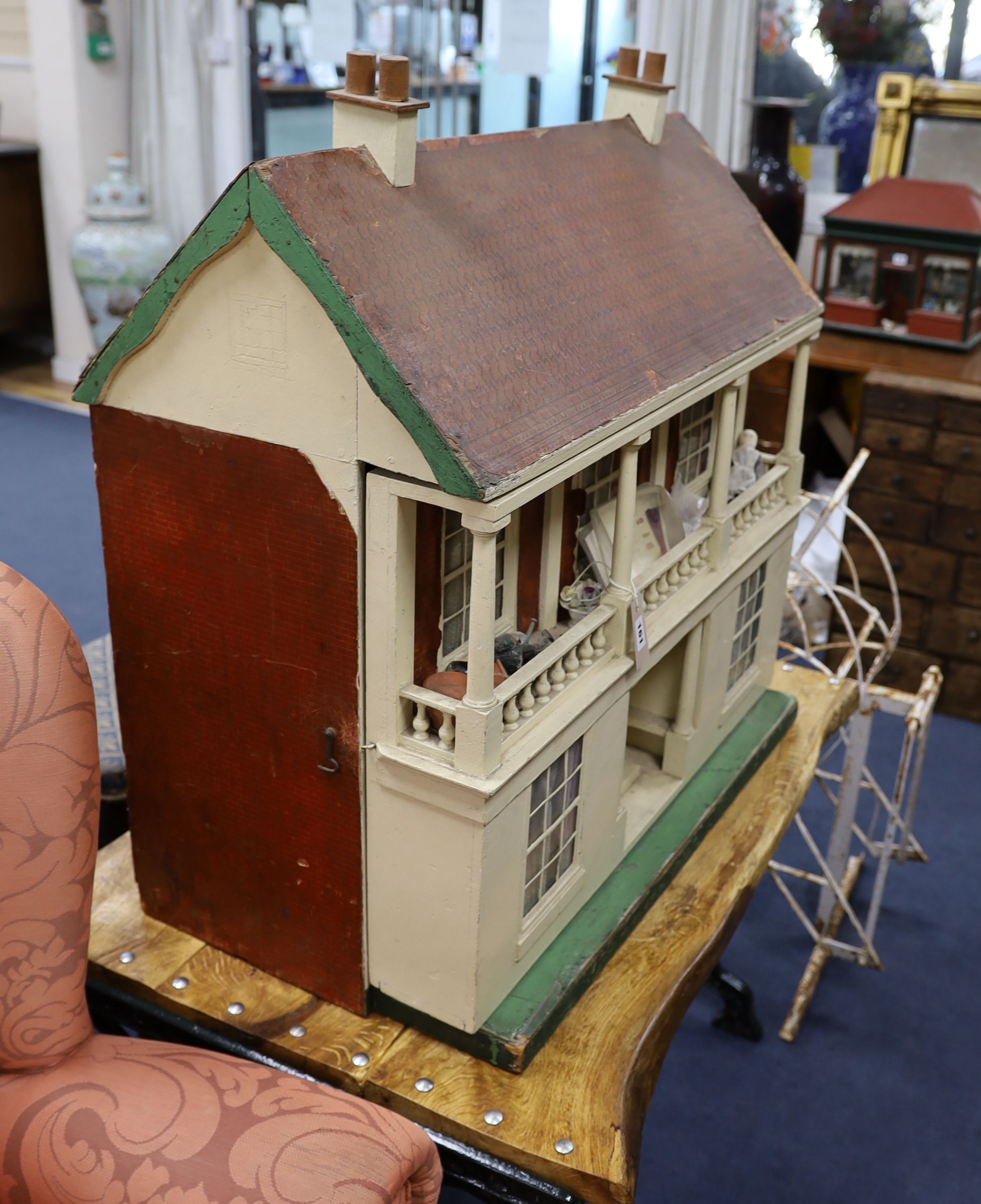 An early 20th century painted dolls house with accessories, width 82cm, height 84cm